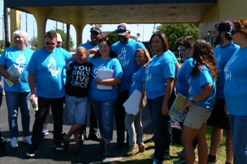 A group of people standing under a gazebo.