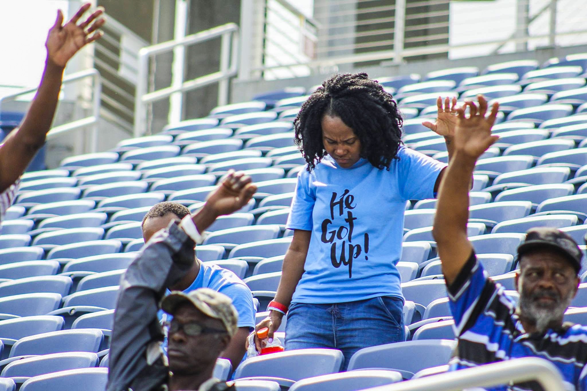 A woman standing in the middle of an audience.