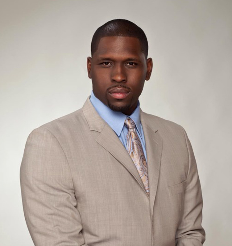 A man in a suit and tie standing up.