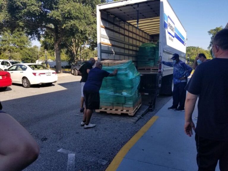 A truck with boxes on it is unloading.