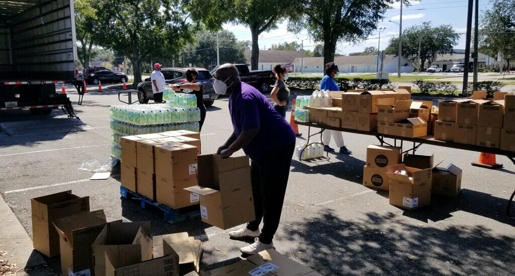 A woman standing next to boxes on the ground.